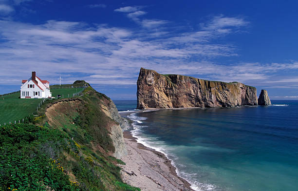 A stunning view of the gaspe perce rock in Quebec Canada Perce rock is a huge sheer rock formation in the Gulf of Saint Lawrence on the tip of the Gaspe Peninsula in Quebec, Canada, off Perce Bay. gulf of st lawrence photos stock pictures, royalty-free photos & images