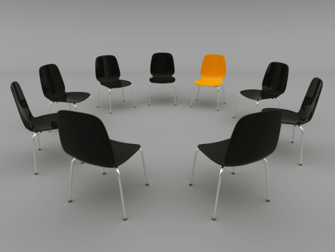 Chairs in a circle with focus on the orange colouredchair concept related lightbox: