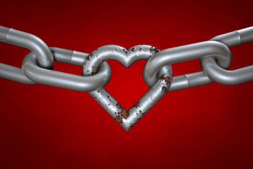 Even rusty, the hart is still important part of the love chain. Chain with rusty heart on red background. Clipping path included.