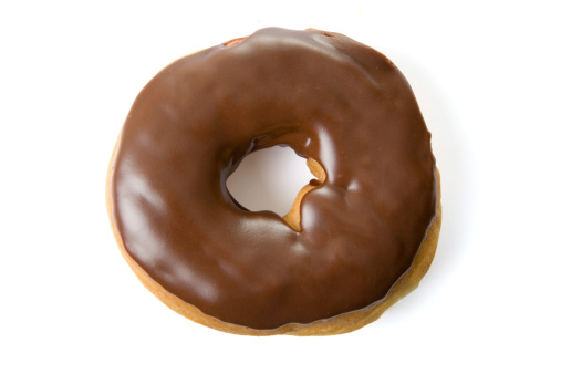 A tempting chocolate glazed donut on white with clipping path.