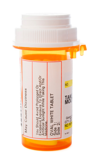 A bottle of prescription medicine isolated against a white background. The labeled container of whit tablet pills holds medications for a patient's healthcare needs during illness or for a chronic, managed health condition. Warnings and instructions are in text on the generic label. No specific or proprietary information is shown.