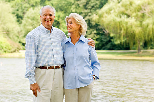 istock Senior Couple Smiling By A Lake 172200484