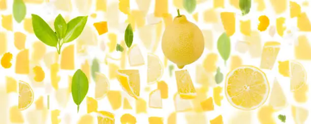 Abstract background made of Lemon fruit pieces, slices and leaves isolated on white.