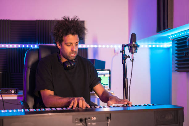 istock Musician playing the piano in a production studio 1722006532