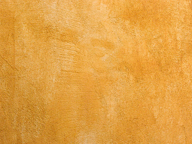 istock Closeup of a Bright Yellow Textured Stucco Wall 172200745