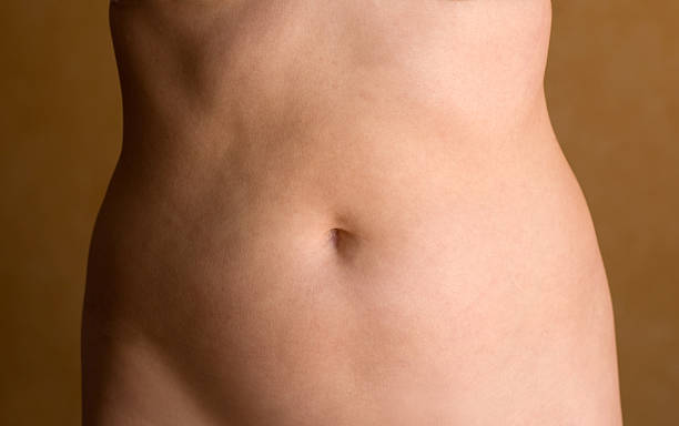 Abdomen 40 yr old female abdomen, real people navel stock pictures, royalty-free photos & images