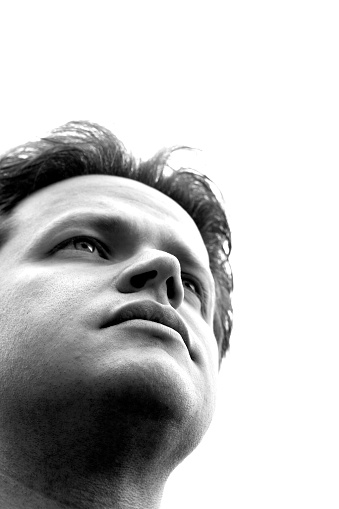 High contrast black and white portrait of a man looking into the distance. (Focus is on the lower half of the mans face)
