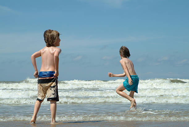 Children having fun in the North Sea surf. 