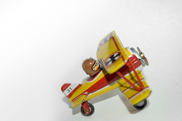 Metal tin toy biplane Small metal toy airplane. iron cross stock pictures, royalty-free photos & images