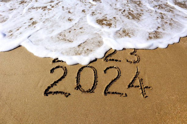 istock New year 2024 and 2023 on sandy beach with waves 1722029173