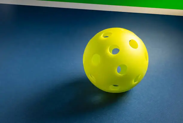 Photo of Close up of pickleball ball on court