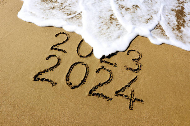 istock New year 2024 and 2023 on sandy beach with waves 1722029729