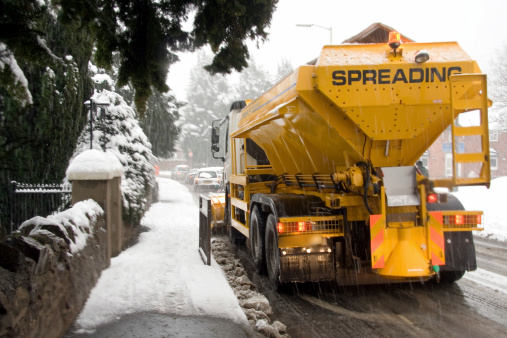 yellow snowplough and gritter in england