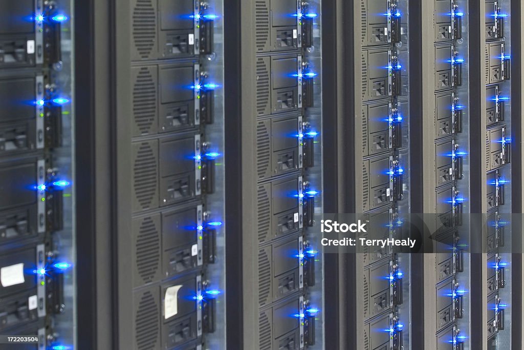 Cluster Computing Rows of racks containing computing cluster systems. Focus is on 3rd rack from right. Black Color Stock Photo