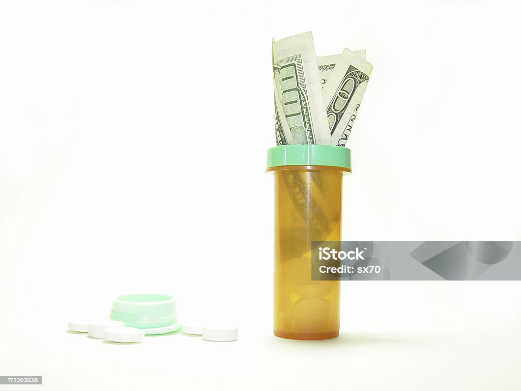 One-hundred dollar bill in drug bottle - Series Part of my cost of drugs series.  Addiction Stock Photo