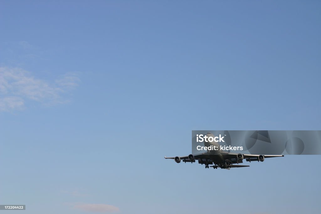 Airplane in lower right corner, blue sky An airplane in the lower right corner of the sky. Air Vehicle Stock Photo