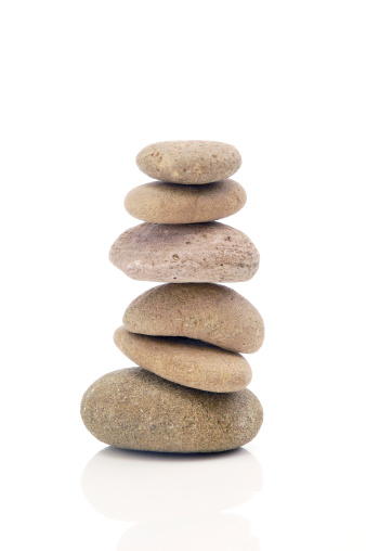 Stack of stones on rock near river, space for text. Harmony and balance concept