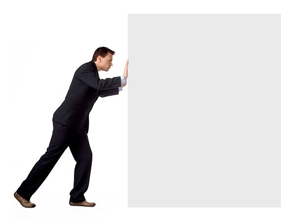 A man in a suit pushing a white box stock photo