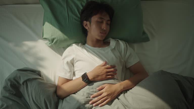 Man wear a smart watch while sleeping.