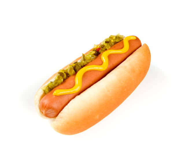A close up of a hot dog in a white bun and mustard and a bite missing. Isolated on white.