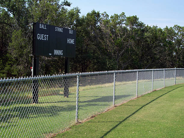 Outfield Fence and Scoreboard Baseball field fence and scoreboard. outfield stock pictures, royalty-free photos & images