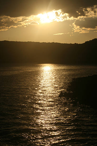 Stormy sunset river reflection stock photo