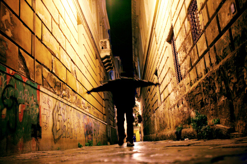 african man walking in narrow street.