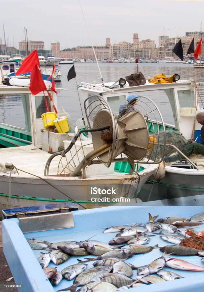 Fishing boats and catch, Marseille "Fishing boats in the Old Port (Vieux Port/Panier quarter), Marseille, with some of the catch on display for sale." Business Stock Photo