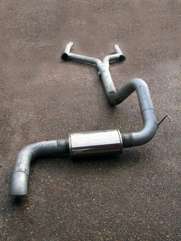Exhaust system with muffler and tailpipes for an auto.