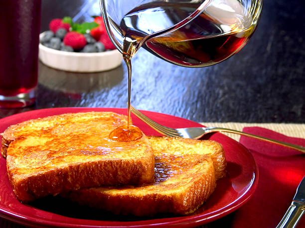 Honey being drizzled onto a thick slice of bread