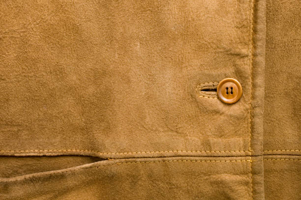 Suede jacket Close-up of pocket and button on old brown suede jacket.See also: leather pocket clothing hide stock pictures, royalty-free photos & images