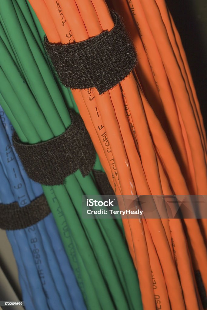 Cable Bundles Tri-color cable bundles inside network switch rack. Focus on foreground (orange) bundle. 8326 Blue Stock Photo