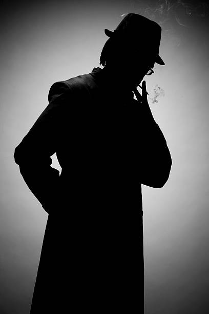 istock Silhouette of a man in a hat smoking, on a gray background 172210163