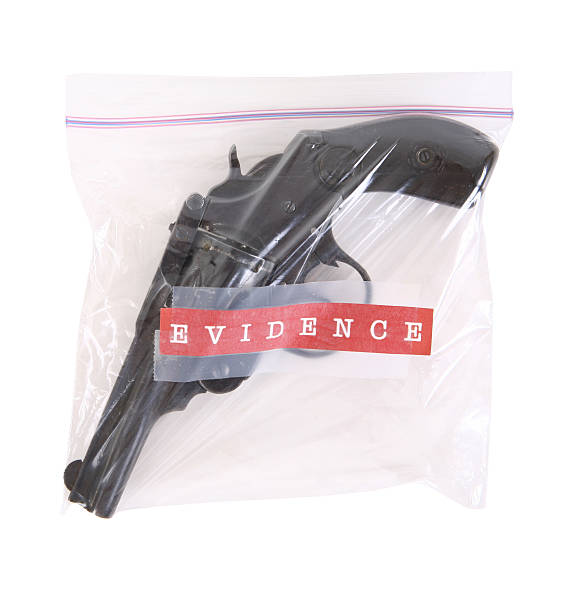 Murder Weapon Gun in plastic evidence bag. evidence bag stock pictures, royalty-free photos & images