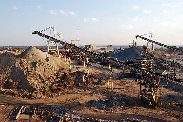 Stockpiles at Sundown "Conveyor belts feed broken rock into two different stockpiles (oxides and sulphides) at an open-pit copper mine in Zambia, Africa." copper mine photos stock pictures, royalty-free photos & images