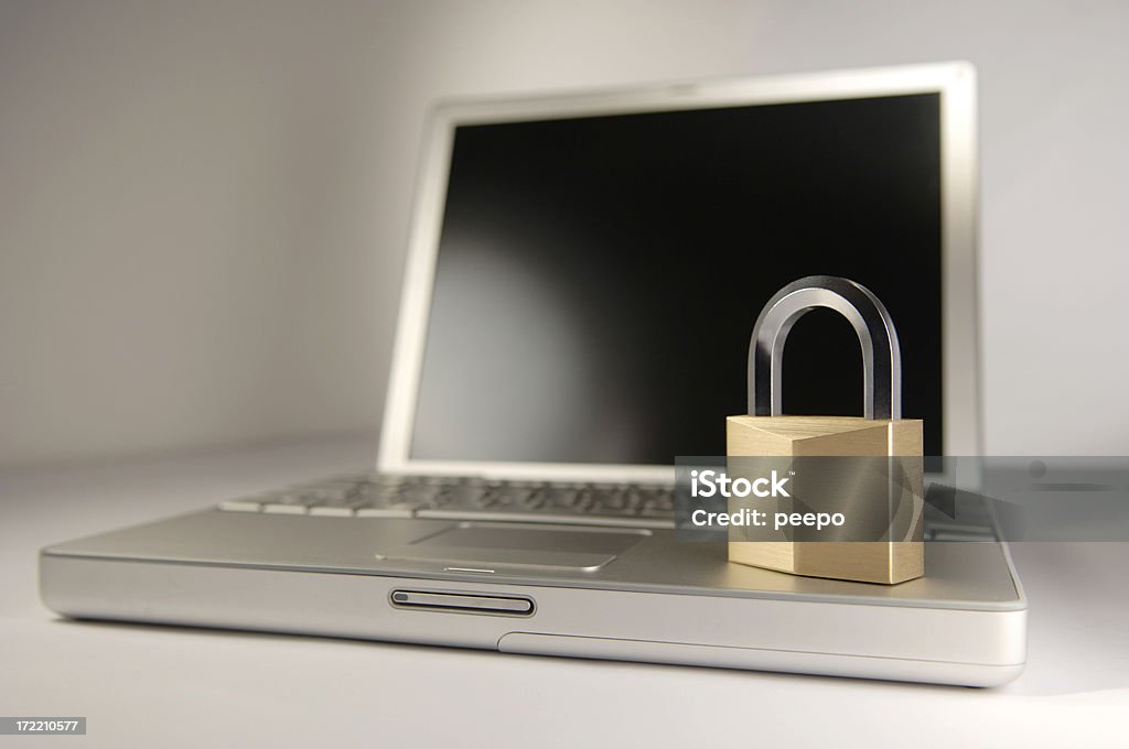 computer security steel and brass padlock on laptop keyboard with shallow depth of field Laptop Stock Photo