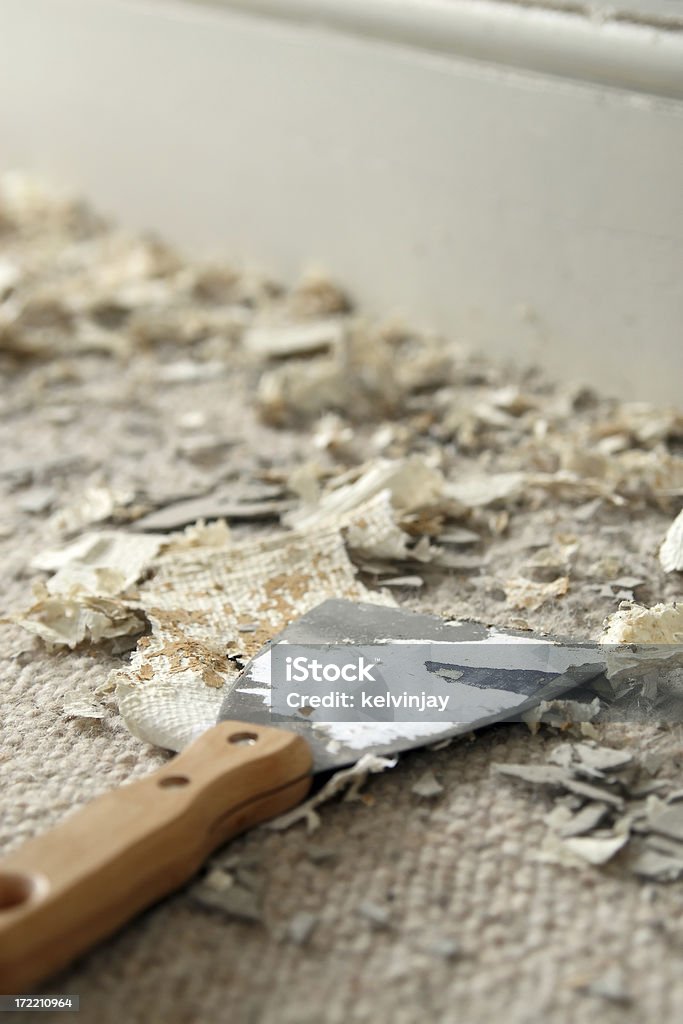 Messy home improvement Mess left from scraping off old wallpaper. Architectural Feature Stock Photo