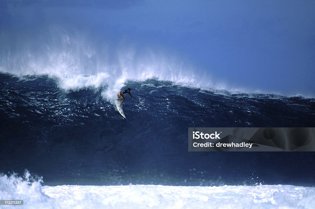 Surfer dropping in at big Pipeline, Hawaii Extreme Surfer dropping in at big Pipeline, Oahu, Hawaii. Horizontal. Surfing Stock Photo