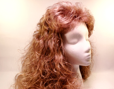 long-haired wig on a white foam head.