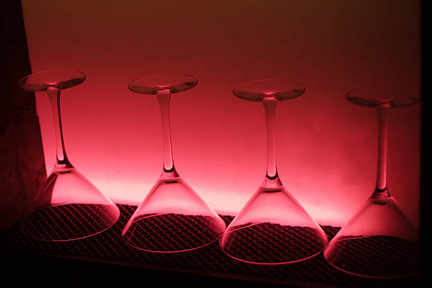 four martini glasses in pink light stock photo