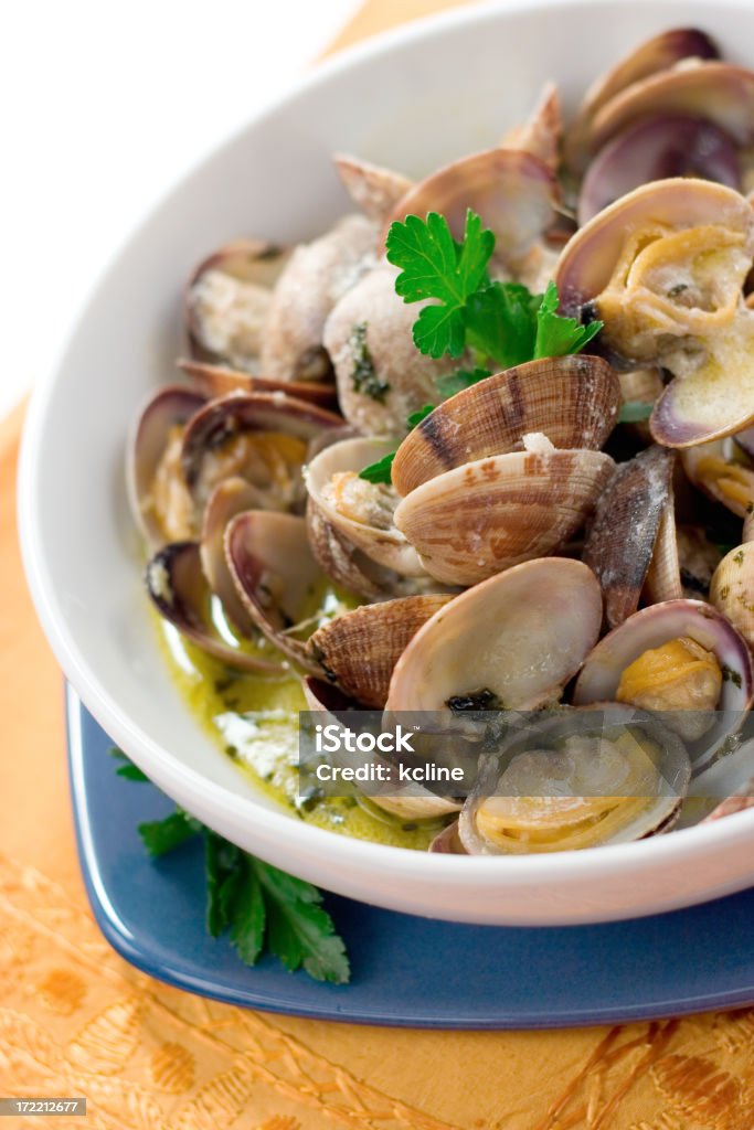 Steamer Clams Delcious manila clams in a rich garlic broth.  Shallow dof Animal Shell Stock Photo