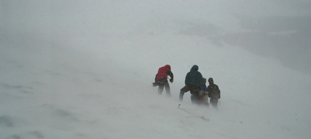 A group of climbers struggling through a blizzard.