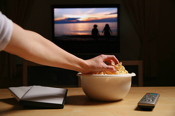 Home Movies and Popcorn  remote control on table stock pictures, royalty-free photos & images