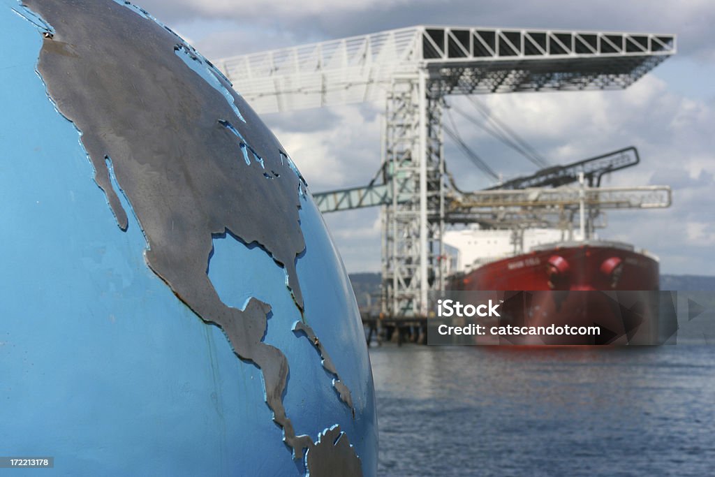 Global Business Concept A globe with focus on the United States (USA) and Central America contrsted against a blurred background of a bulk cargo ship exemplifying the global nature of the cargo industry. Look at more Tariff Stock Photo