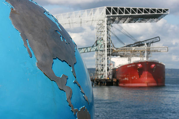 Global Business Concept A globe with focus on the United States (USA) and Central America contrsted against a blurred background of a bulk cargo ship exemplifying the global nature of the cargo industry. Look at more north pacific ocean globe stock pictures, royalty-free photos & images