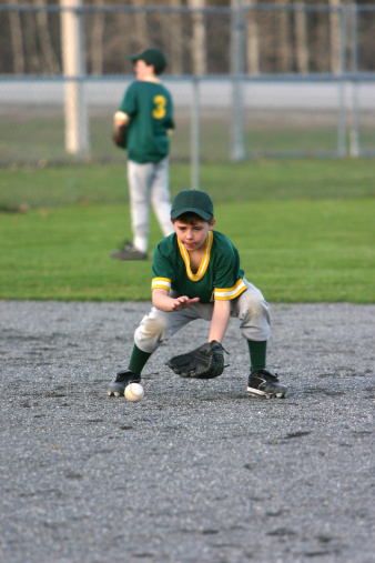 young boy catching a grounderCheck out my youth sports gallery http://www.istockphoto.com/my_lightbox_contents.phplightboxID=21510These and more baseball images in my portfolio