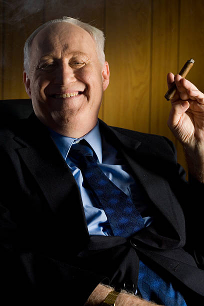 Rich and Happy Old Rich Man Smoking a Cigar man cigar stock pictures, royalty-free photos & images