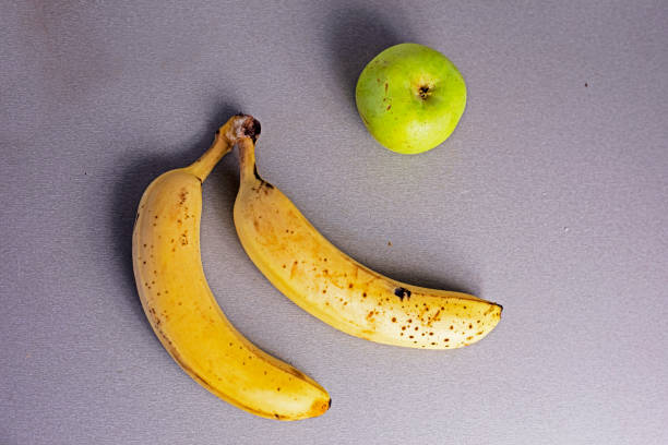 istock ripe bananas with green apple on a gray table. flatlay 1722139077