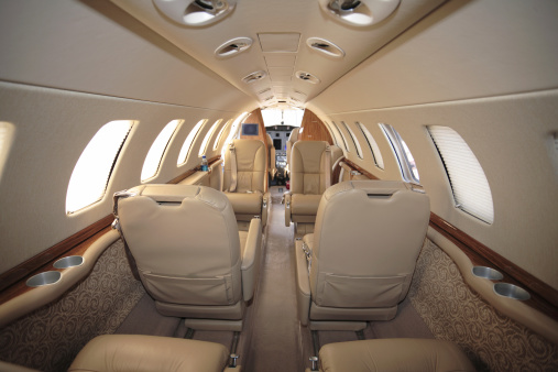 Small airplane parked on a runway with door open