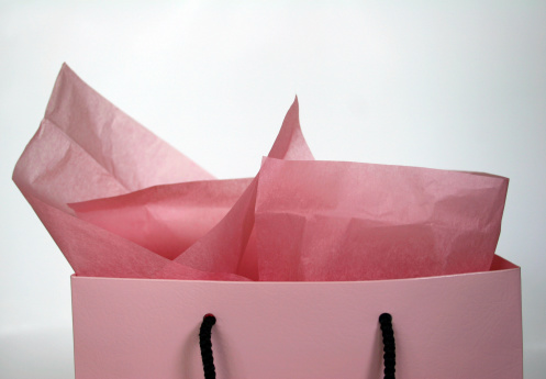 Top of a pink gift bag with pink tissue paper. See also: